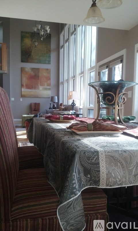 A dining room with a long table set for a meal.
