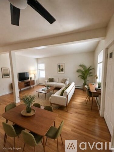 A living room with a wooden table and chairs.