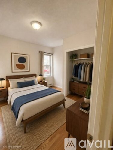 A bedroom with a large bed and a wooden nightstand.
