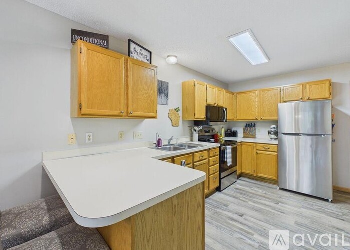 A kitchen with wooden cabinets and a white countertop.