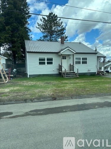 A house with a metal roof and a porch.