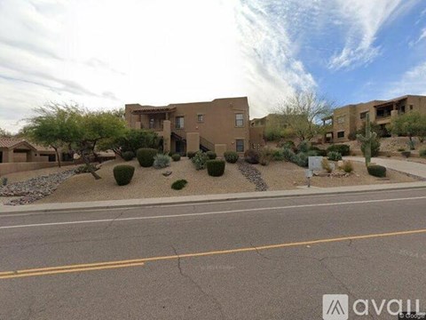 A row of houses with a street in front.