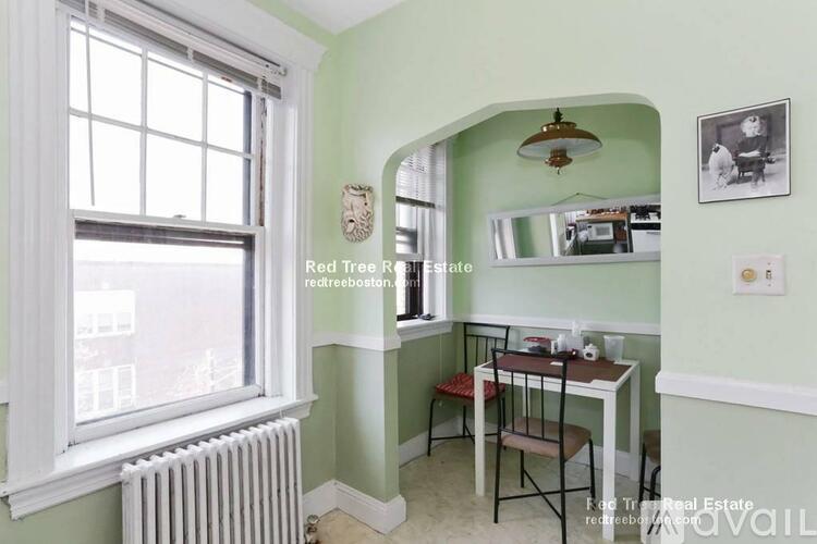 A room with a table and chairs in it.