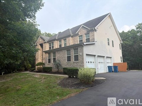 A large house with a driveway in front of it.