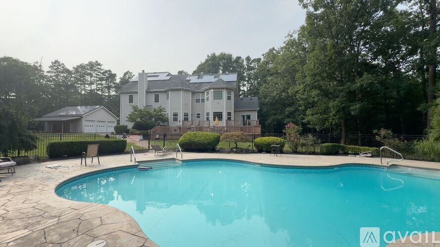 A large house with a pool in the backyard.