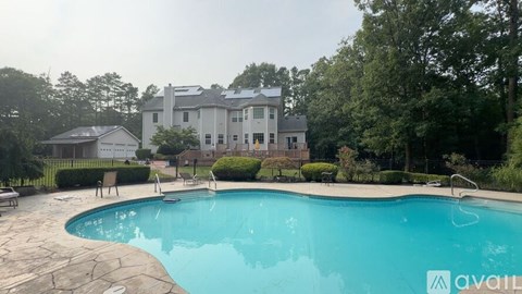 A large house with a pool in the backyard.