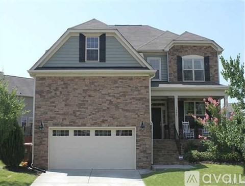 A two-story house with a garage and a front porch.