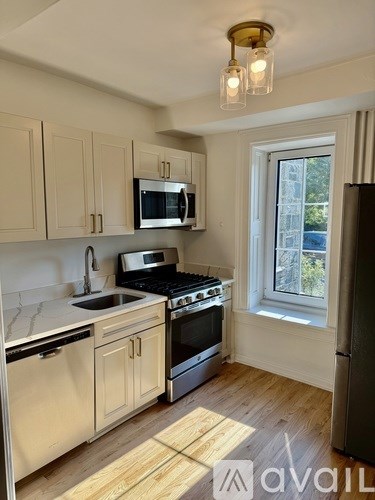A kitchen with wooden cabinets and stainless steel appliances.