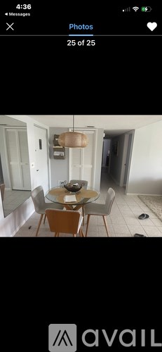 A dining room with a round table and chairs.