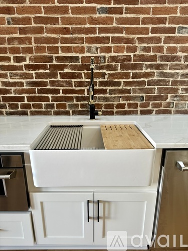 A kitchen sink with a wooden board on top of it.