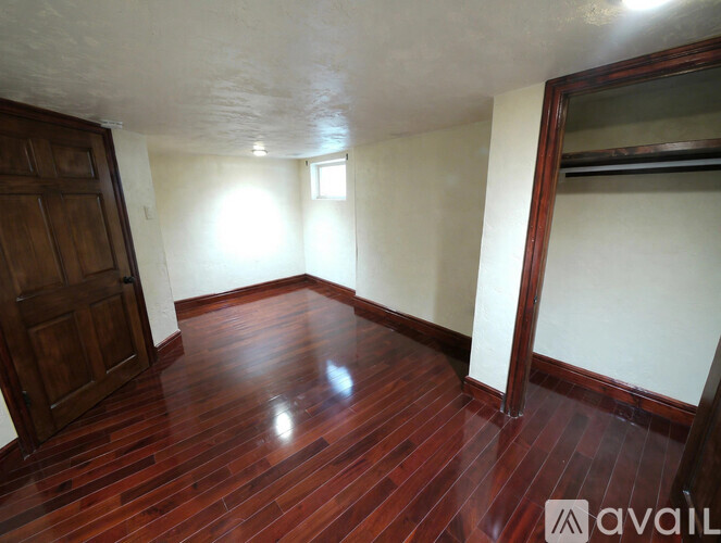 A room with wooden floors and a large wooden door.