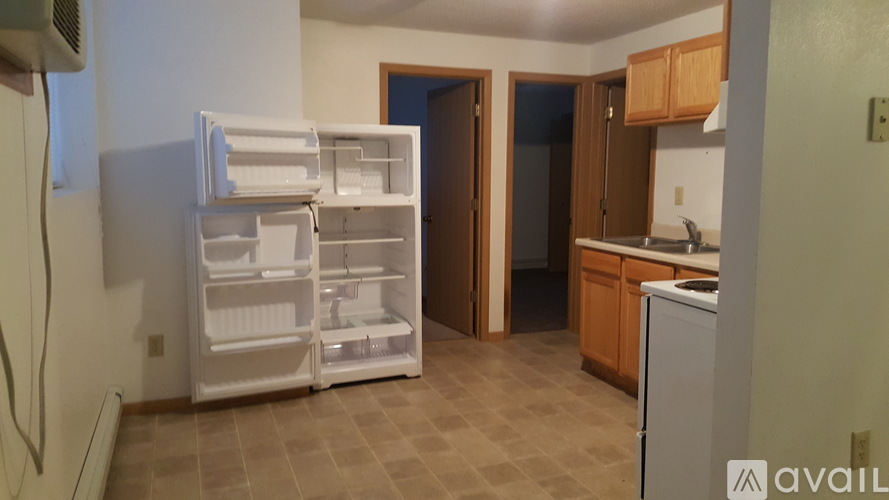 A kitchen with a white refrigerator and a white dishwasher.