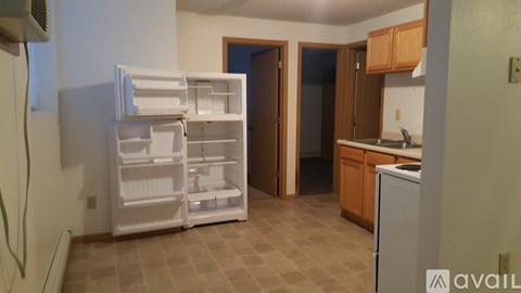 A kitchen with a white refrigerator and a white dishwasher.