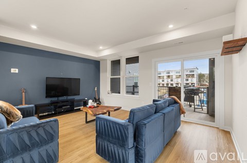 A living room with a dark blue couch and a television.