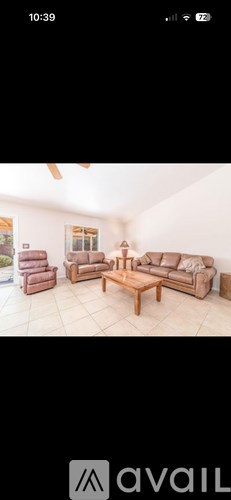 A living room with a brown sofa and a wooden coffee table.