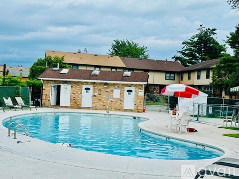 A pool with a building behind it.