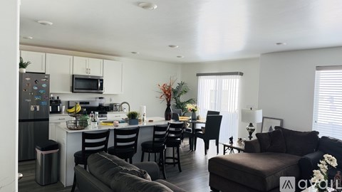 A modern kitchen with a dining table and chairs.