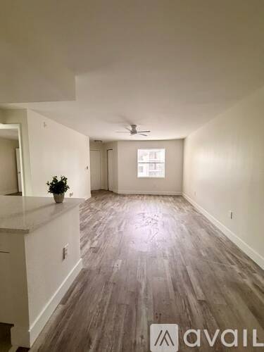 A spacious room with a ceiling fan and a window.
