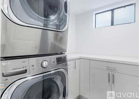 A stack of LG washing machines in a laundry room.