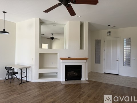 A living room with a fireplace and a dining table.