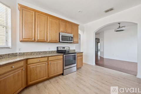 A kitchen with wooden cabinets and stainless steel appliances.