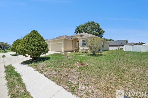 A house with a front yard and a sidewalk in front of it.