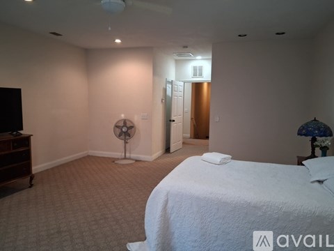 A bedroom with a large bed and a television.