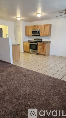 A kitchen with wooden cabinets and a white refrigerator.