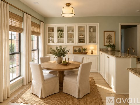 A dining room with a round table and chairs.