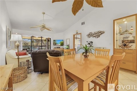 A dining room with a wooden table and chairs.