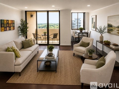 A living room with a white couch, a coffee table, and a view of the city.