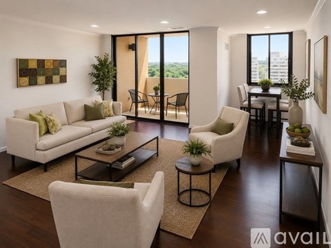 A living room with a couch, chairs, and a coffee table.