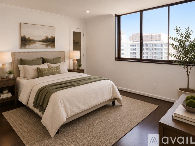 A bedroom with a large bed and a painting on the wall.