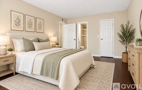 A bedroom with a large bed, a nightstand, and a mirror.