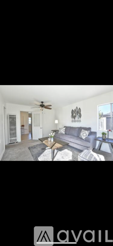 A living room with a grey couch and a coffee table.
