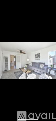 A living room with a grey couch and a coffee table.
