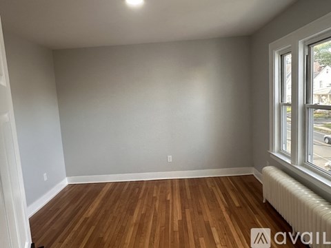 A room with wooden floors and a window.