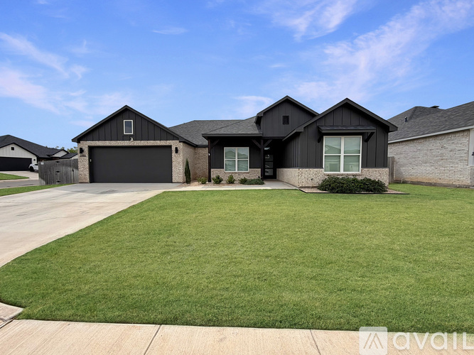 A modern house with a large front yard.