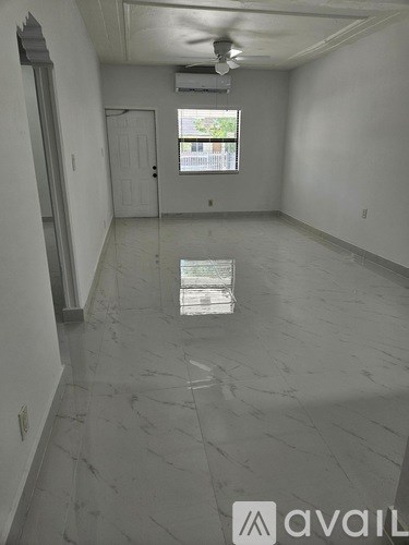 A room with a marble floor and a window.