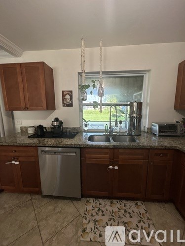 A kitchen with a sink and a window.