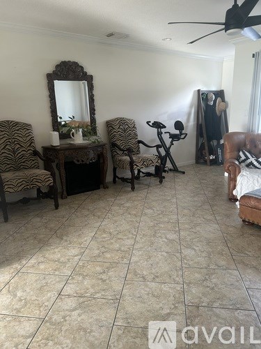 A living room with a zebra print chair and a wooden table with a mirror.