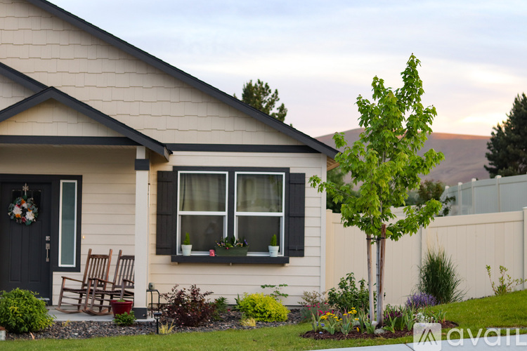A house with a black door and a wreath on it.