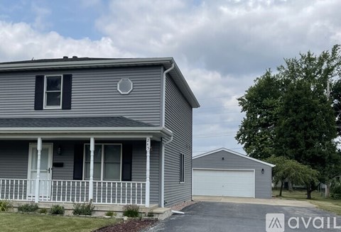 A house with a grey exterior and a white porch.