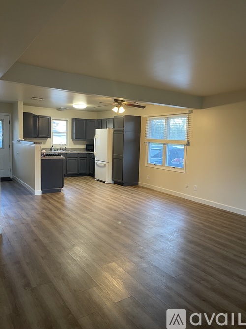 A kitchen with wooden floors and a window.