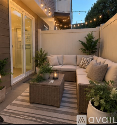 A patio with a white couch and a coffee table.