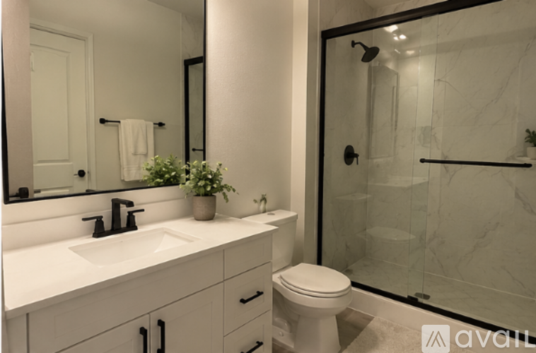 A bathroom with a white sink and toilet.