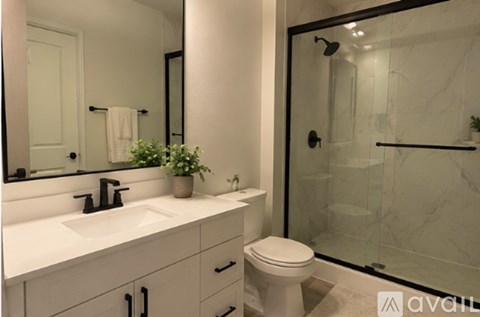 A bathroom with a white sink and toilet.