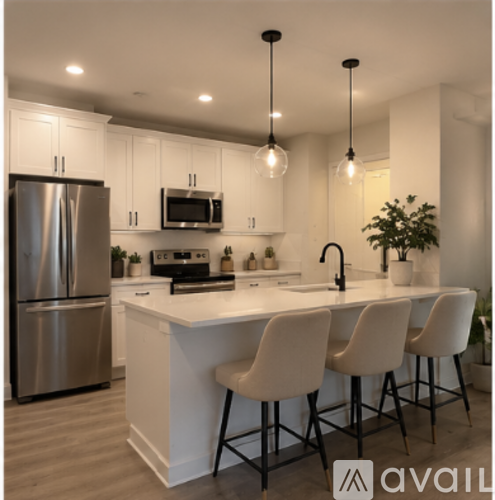 A modern kitchen with white cabinets and a large island.