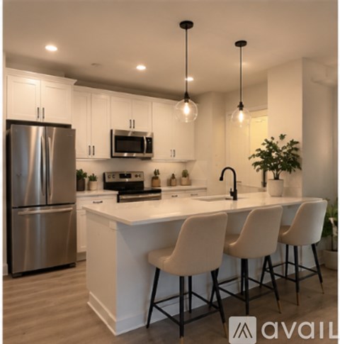 A modern kitchen with white cabinets and a large island.