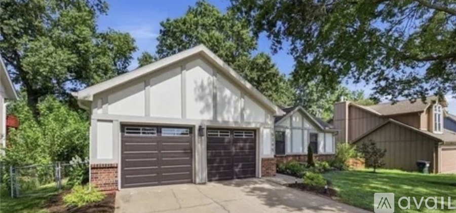 A two-car garage with a white exterior and a brown roof.